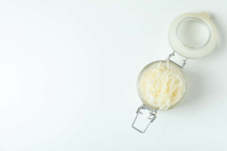 Glass jar of sauerkraut on white background