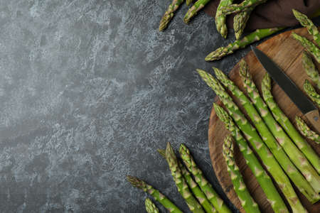 Cutting board with asparagus on black smokey backgroundの写真素材