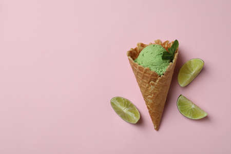Cone of mint ice cream on pink backgroundの写真素材