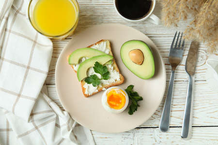 Concept of tasty breakfast with boiled egg, top view