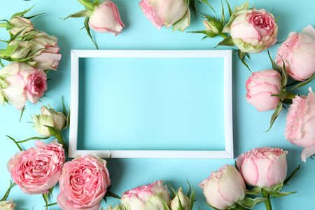 Roses and empty frame on blue background, space for textの写真素材