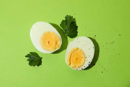 Tasty boiled eggs on green background, top viewの写真素材