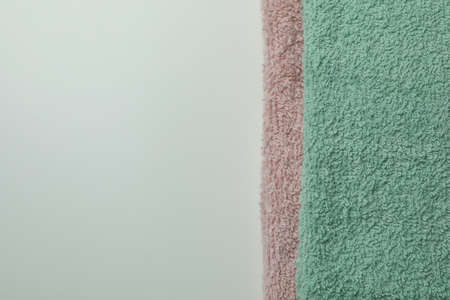 Clean folded towels on light gray background, space for textの写真素材