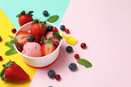 Fruit ice cream and ingredients on color backgroundの写真素材