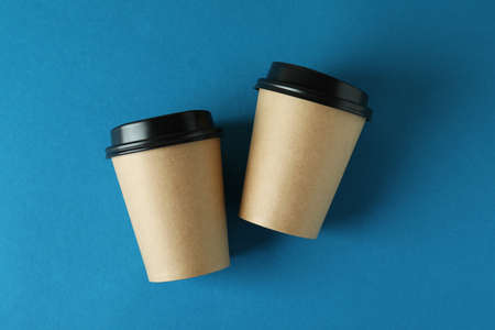 Blank paper cups on blue background, space for textの写真素材