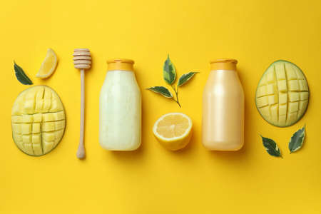 Natural mango shower gel and ingredients on yellow backgroundの写真素材