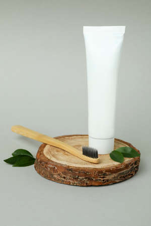 Oral care accessories on gray background, blank tubeの写真素材