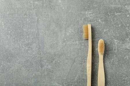 Eco friendly wooden toothbrushes on gray backgroundの写真素材