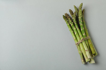 Bunch of fresh asparagus on light gray backgroundの写真素材