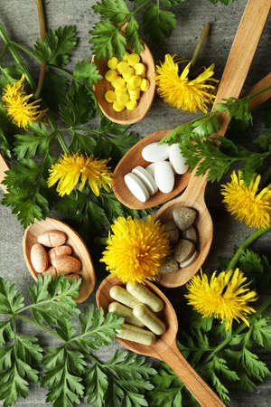 Concept of herbal medicine pills on gray textured background, top viewの写真素材