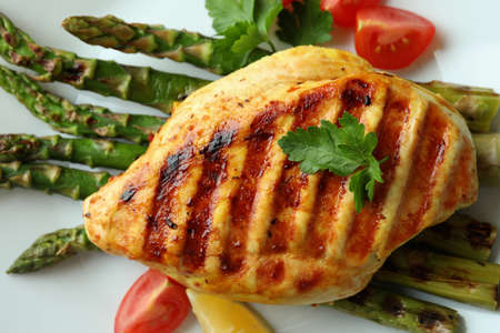 Plate with grilled chicken and ingredient, close up