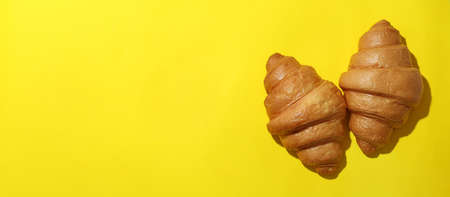 Tasty croissants on yellow background, space for textの写真素材