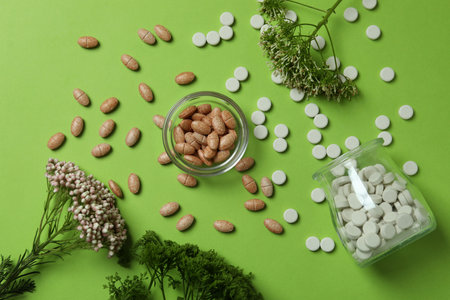 Concept of herbal medicine pills on green background, top viewの写真素材