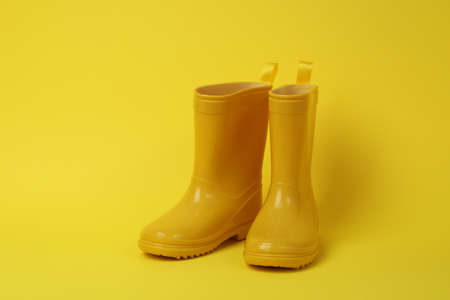 Rubber boots for gardening on yellow backgroundの写真素材