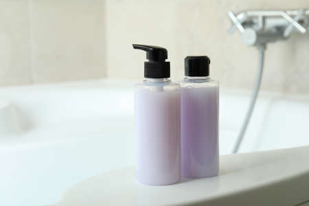 Shower gel bottles on bath, close upの写真素材