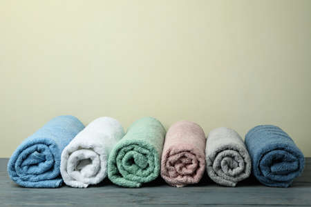 Clean rolled towels against beige background, space for textの写真素材