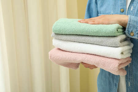 Young woman hold clean towels, space for textの写真素材