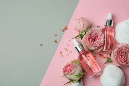 Skin care concept with essential rose oil on two tone backgroundの写真素材