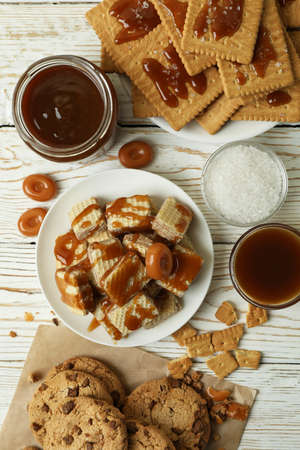 Tasty snack concept with cookies with caramel on white wooden tableの写真素材