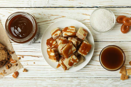Tasty snack concept with cookies with caramel on white wooden tableの写真素材