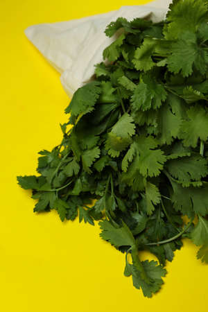 Bag with parsley on yellow background, close upの写真素材