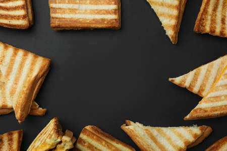 Tasty grilled sandwiches on black background, space for textの写真素材