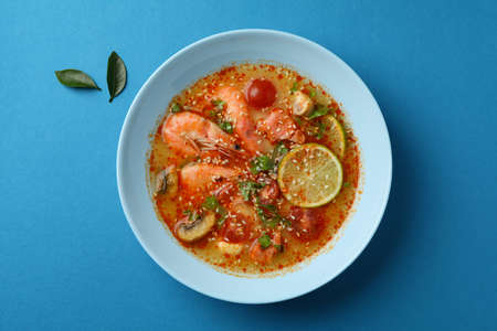 Tasty Tom yum soup on blue backgroundの写真素材