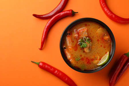 Tasty Tom yum soup on orange background