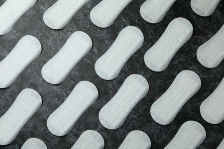 Sanitary pads on black smokey background, top viewの写真素材