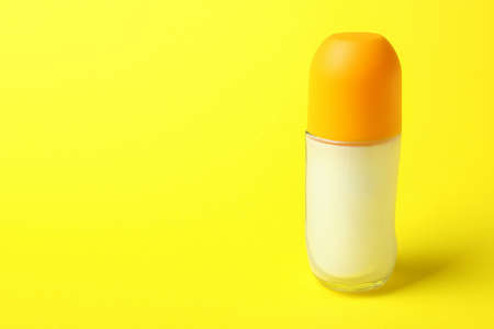 Blank roll-on deodorant on yellow background, space for textの写真素材