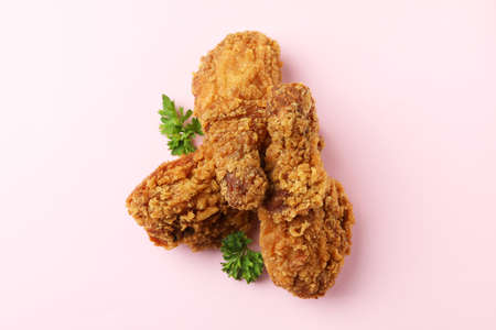 Tasty fried chicken on pink background, close upの写真素材