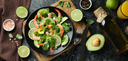 Concept of tasty eating with shrimp salad on black smokey backgroundの写真素材