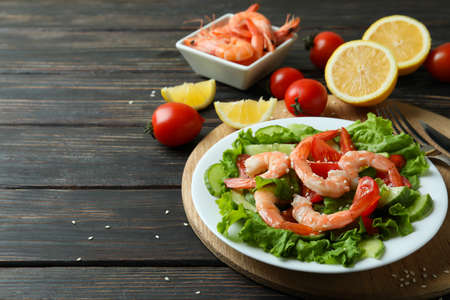 Concept of tasty eating with shrimp salad on wooden tableの写真素材