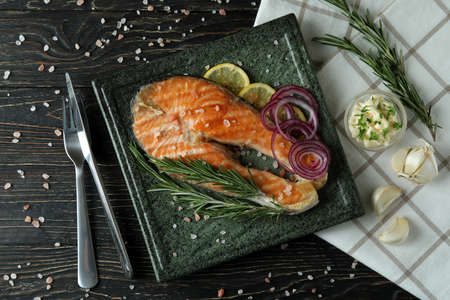 Concept of tasty eating with grilled salmon, top view