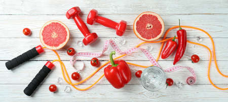Healthy lifestyle accessories on white wooden table