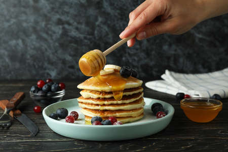 Concept of delicious dessert with pancakes on wooden tableの写真素材