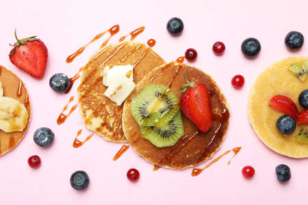 Concept of delicious dessert with pancakes on pink backgroundの写真素材