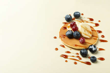 Concept of tasty food with pancake on beige backgroundの写真素材