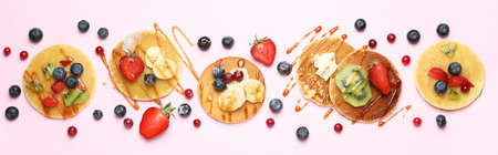 Concept of delicious dessert with pancakes on pink backgroundの写真素材