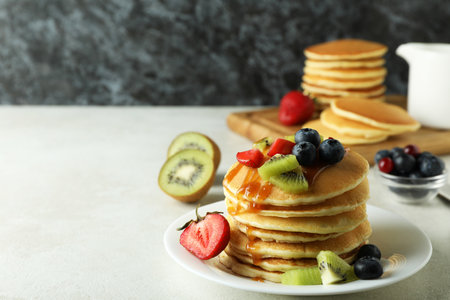 Concept of delicious dessert with pancakes on white textured tableの写真素材
