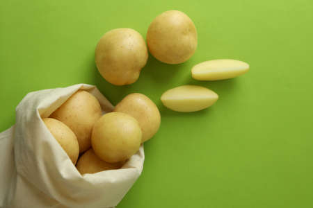 Bag of young potato on green backgroundの写真素材