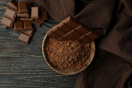 Tasty chocolate bars and powder on wooden tableの写真素材