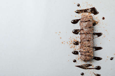 Candy bar with sauce and powder on gray backgroundの写真素材