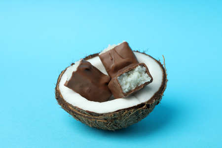 Coconut with candy bars on blue backgroundの写真素材