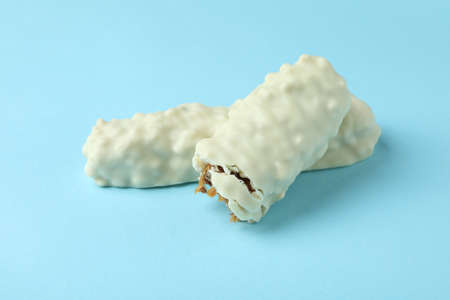 Tasty white candy bars on blue background