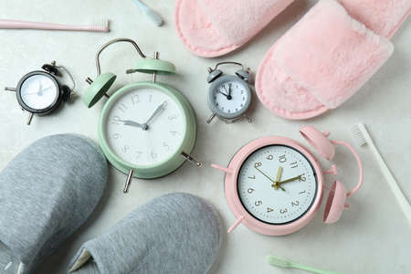 Different sleep routine accessories on white textured tableの写真素材