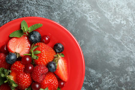Plate with berry mix on black smokey backgroundの写真素材