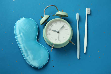 Different sleep routine accessories on blue background