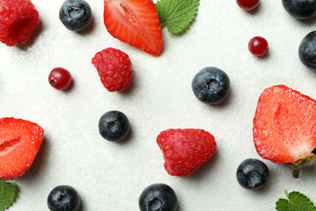 Delicious fresh berry mix on white textured backgroundの写真素材