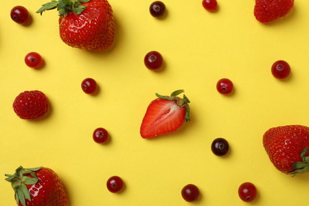 Delicious fresh berry mix on yellow background